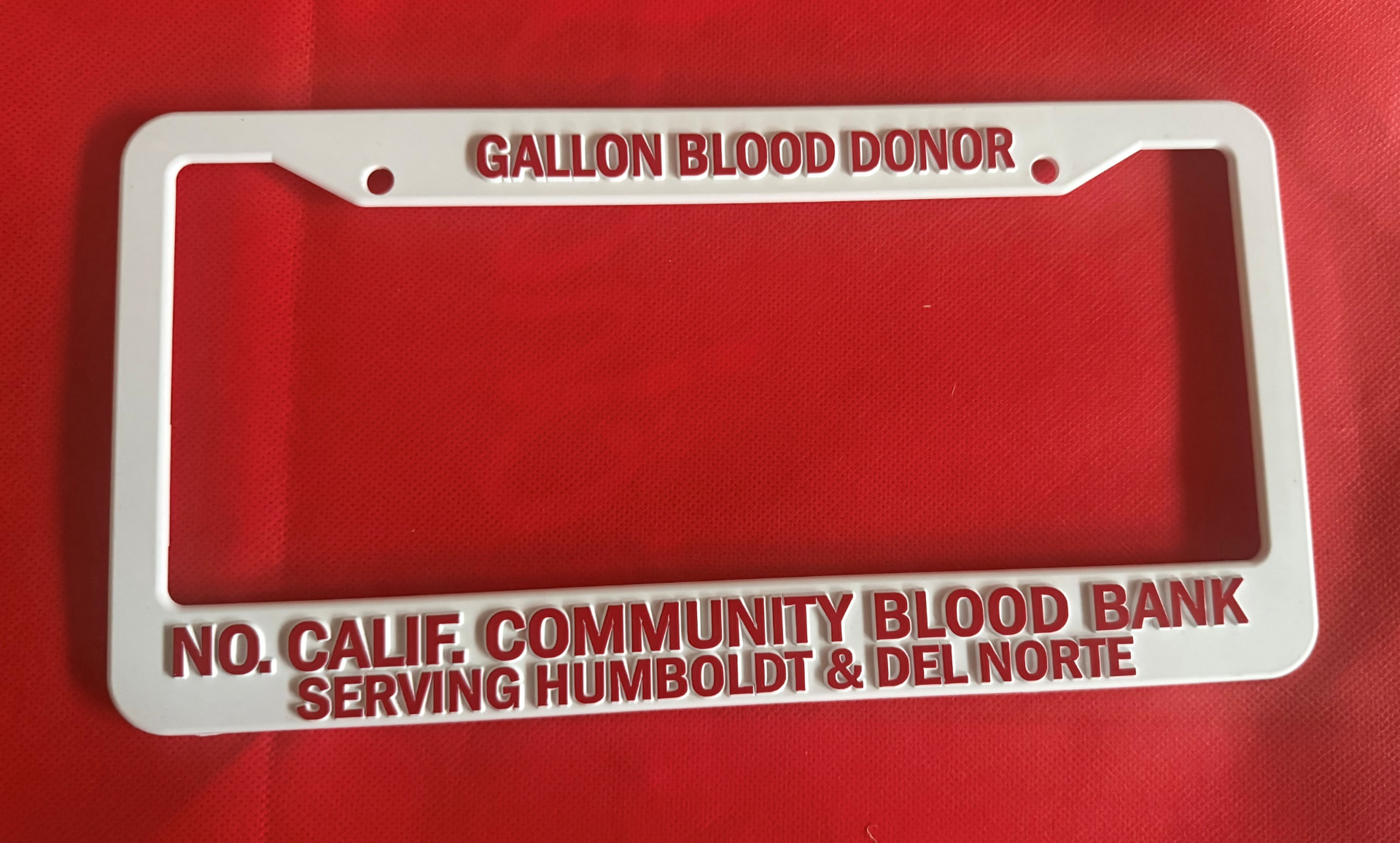 White gallon blood donor license plate frame from the Northern California Community Blood Bank