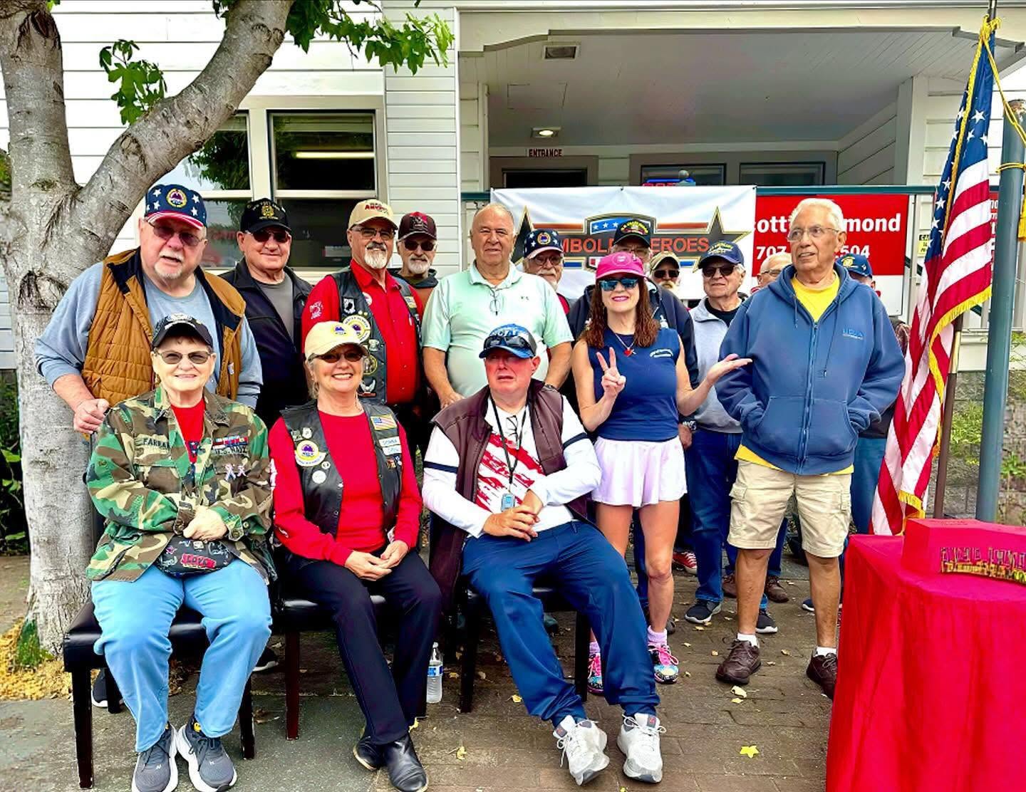 Veterans and supporters gathered in front of a Humboldt Heroes banner