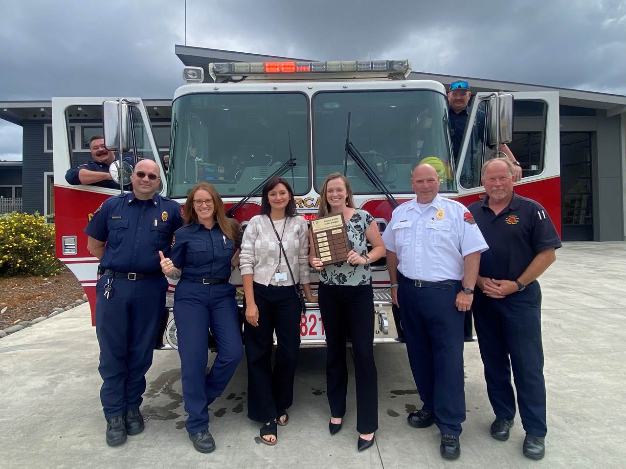 Local firefighters accepting a community award